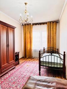 a bedroom with a bed and a large window at Cottage Лома city center 7 to 2 floor in Taldykorgan +8 photos
