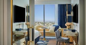 a hotel room with a view of a living room at The Sun Rose West Hollywood in Los Angeles
