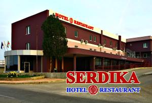 a hotel building with a sign in front of it at Hotel Serdica in Silistra