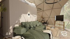 a living room with a green couch and a tv at Glamping "Letnisko WISOLA" in Ciemnik