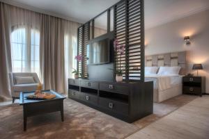 a bedroom with a bed and a dresser with a mirror at Hotel Moskva in Budva