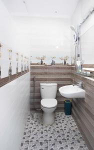 a bathroom with a toilet and a sink at HeavenVilla in Can Tho