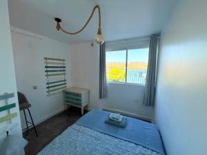 a bedroom with a blue bed and a window at Mirador del Mar in Puerto de Mazarrón