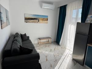 a living room with a black couch and a window at Sea View Chic Apartment in Karianí