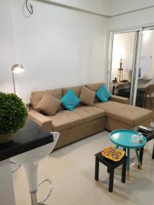 a living room with a couch and a table at La Vista One The Cosy Sofa-Bed Studio in Chennai