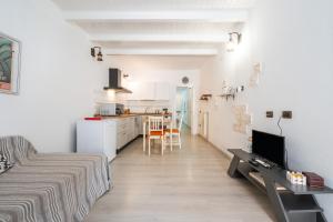a white apartment with a kitchen and a living room at St John Apartment in Cagliari