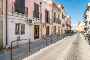 a street in an old town with buildings at St John Apartment in Cagliari