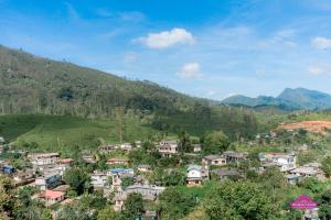 a village on a hill with mountains in the background at Prabhaz Grand in Hatton