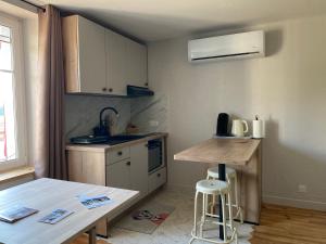 a small kitchen with a counter and a table at Gîte PREY DES VOSGES in Prey