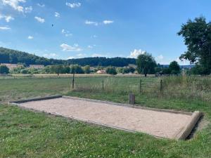 a sandbox in the middle of a field at Gîte PREY DES VOSGES in Prey