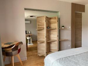 a bedroom with a closet and a bed and a desk at Gîte PREY DES VOSGES in Prey