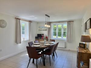 a dining room with a table and chairs at South Glebe in Hawkchurch