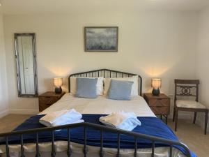 a bedroom with a bed with two towels on it at South Glebe in Hawkchurch