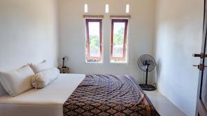 a bedroom with a bed and a window at Private Cozy House in Nembrala