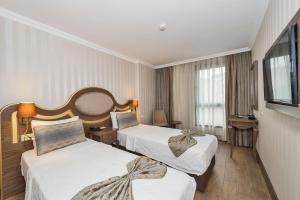 A bed or beds in a room at The Central Hotel