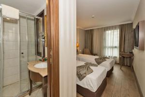 A bed or beds in a room at The Central Hotel