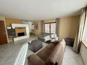 a large living room with a couch and a table at Villa Monti in Courmayeur