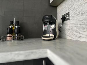 a coffee maker sitting on top of a counter at Modern House with four BR two parking bays in Bolton in Bolton