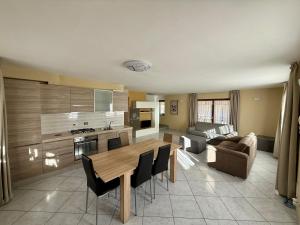 a kitchen and living room with a table and a couch at Villa Monti in Courmayeur