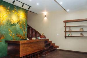 a room with a staircase and a painting on the wall at Ngải Spa, Body, Foot Massage in Hanoi