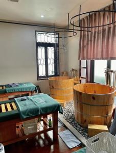 a room with wooden tables and a wooden tub at Ngải Spa, Body, Foot Massage in Hanoi