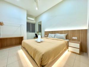 a bedroom with a bed with a teddy bear on it at Klebang Cozy Homestay in Chemor