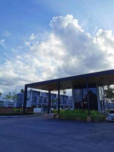 a building with a car parked in a parking lot at AzureGreen at AmanPlus Kuantan in Kuantan