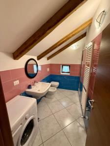 a bathroom with a sink and a washing machine at Villa Monti in Courmayeur