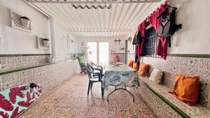 a dining room with a table and a snowboard at Beach house MAREA CORAL in Melilla