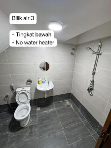 a bathroom with a toilet and a sink at AzureGreen at AmanPlus Kuantan in Kuantan +6 photos