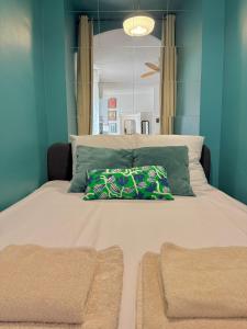 a bedroom with a large bed with a pillow on it at Mourillon proche plages in Toulon