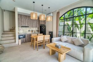 a living room with a couch and a table at Coco Lifestyle Residence in Canggu