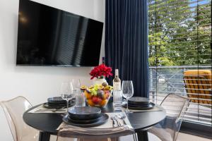 a dining room table with a bowl of fruit and wine glasses at Penthouse Apartment - 10 min to Cologne & Parking in Hürth