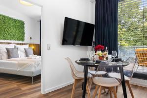 a living room with a table and chairs and a couch at Penthouse Apartment - 10 min to Cologne & Parking in Hürth