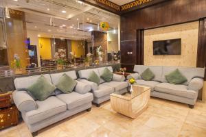 a large living room with couches and a tv at THE PARK HOTEL Formerly Al Jawhara Gardens in Dubai