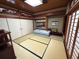 a room with a bed in a room with windows at Matsu no Yama, center of Goto, rent the whole house, maximum 7 people in Goto