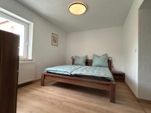 a bedroom with a bed and a window at FeWo zum Büttelfels in Dahn +9 photos