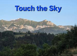 a view of a mountain range with the words touch the sky at Touch the Sky in Moieciu de Jos