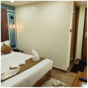 a hotel room with a bed and a mirror at The House Hotel Darjeeling in Darjeeling