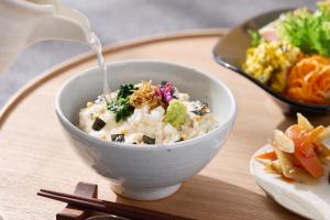 a bowl of food with water being poured into it at OMO5 Kyoto Sanjo by Hoshino Resorts in Kyoto