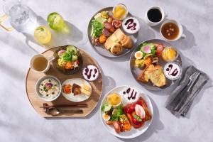 a table topped with plates of food and drinks at OMO5 Kyoto Sanjo by Hoshino Resorts in Kyoto