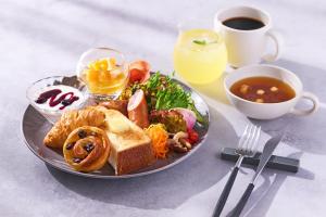 a plate of food with bread and soup and a cup of coffee at OMO5 Kyoto Sanjo by Hoshino Resorts in Kyoto