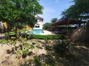 a house with a swimming pool in a yard at Campement Houefa in Ndangane
