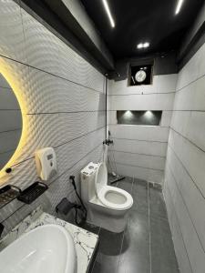 a bathroom with a toilet and a sink at Single Room With Separate Entrance in Karachi