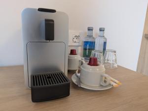 a coffee machine sitting on top of a wooden table at Hotel San Lorenzo Boutique Catedral in Valencia