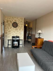 a living room with a couch and a fireplace at Résidence T2 , Jardin 100m plage Parking gratuit in Valras-Plage