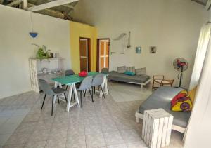 a living room with a table and chairs and a couch at appartement lagon blue in Mahébourg