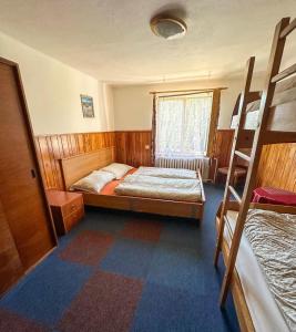 a bedroom with a bed and bunk beds in it at Horská chata Amor in Pec pod Sněžkou +21 photos
