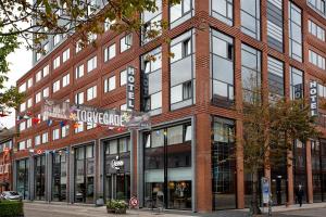 a brick building with a street sign in front of it at Cabinn Plus Esbjerg in Esbjerg