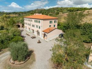 an aerial view of a large white building with a red roof at Agriturismo Antica Fonte in Rosignano Marittimo